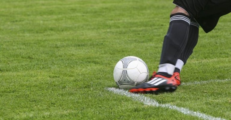 Hobbies - Soccer Player Kicking White Gray Soccer Ball on Green Grass Field