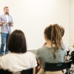 Classes - Man Wearing Gray Dress Shirt and Blue Jeans