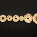 Progress - Photo of Golden Cogwheel on Black Background