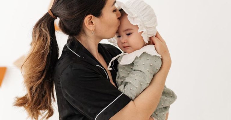 Co-Parenting - Young Mother Holding a Baby Girl