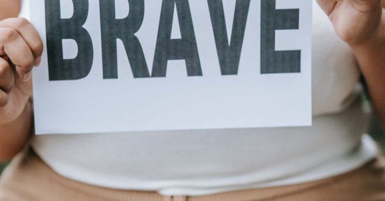 Self-Love - Woman Holding Paper with Brave Written on It