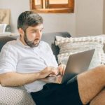 Home Office - A Man Using a Laptop