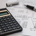 Budget - Black Calculator Near Ballpoint Pen on White Printed Paper