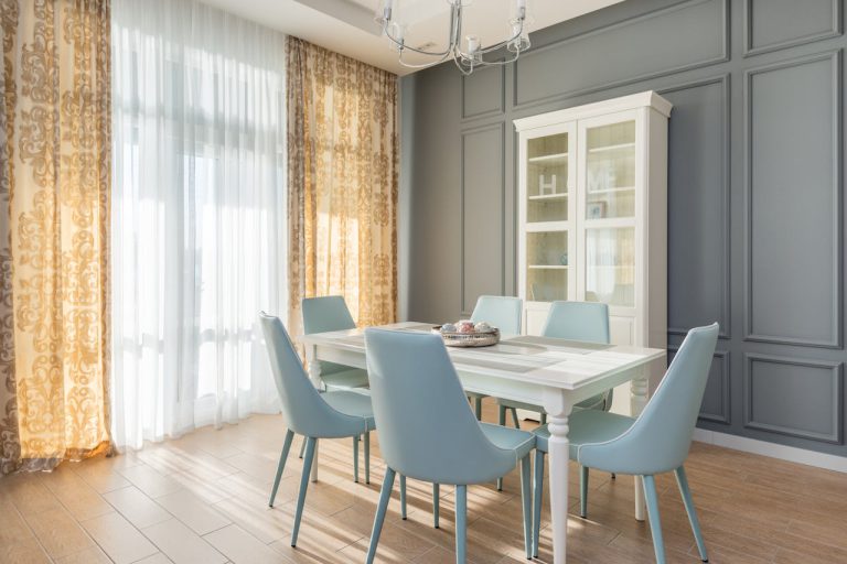 a-dining-table-with-chairs-near-the-white-cabinet